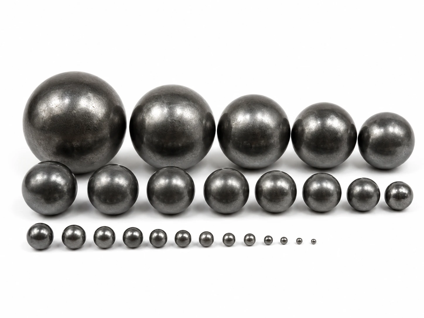 Carbon steel grinding balls graded from large to small for reducing particle size during milling