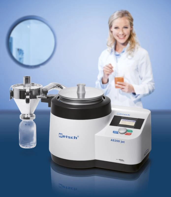 RETSCH AS 200 jet Air Jet Sieving Machine for separating particles by size, shown beside a technician holding a powder sample